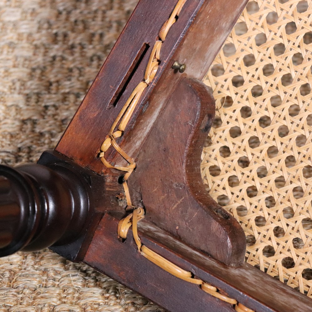 A set of six Regency period side chairs crafted from dark Goncalo Alves timber featuring carved crest rails, detailed backsplats, turned front legs, and hand-woven cane seats. View XIV