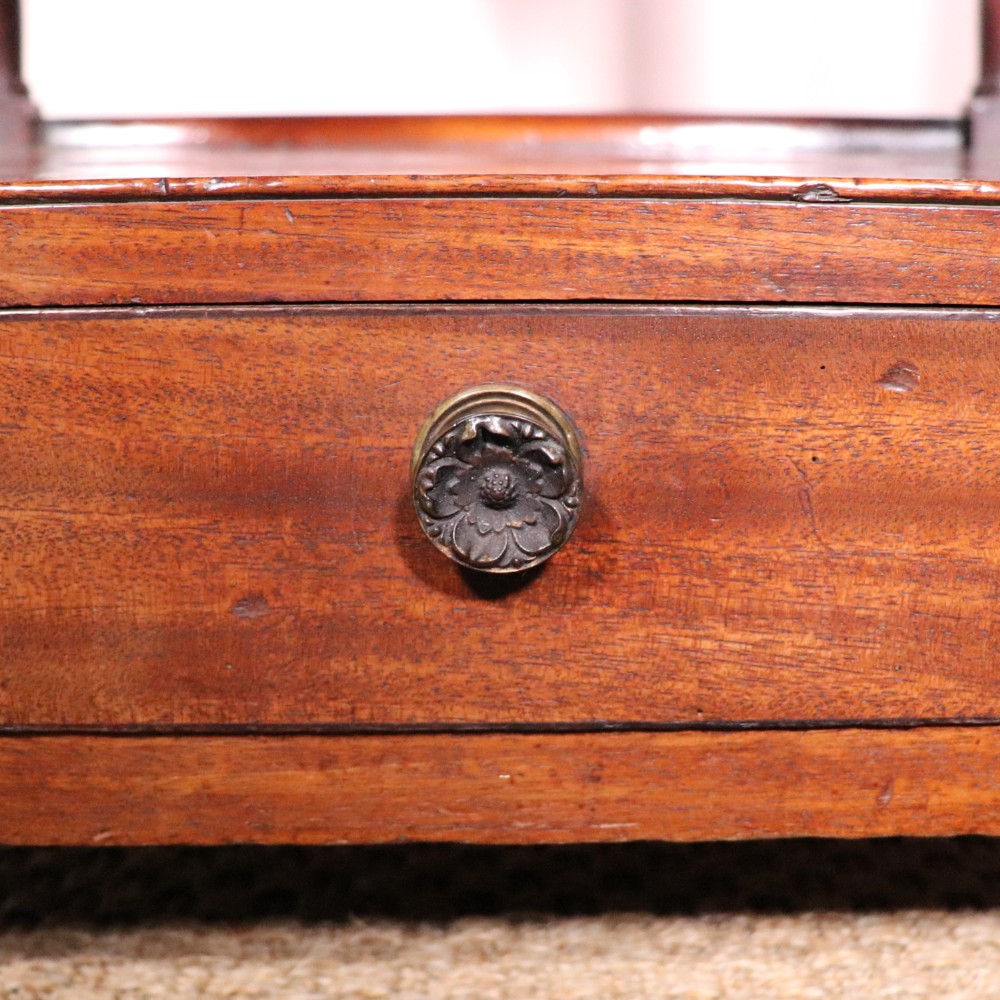 A matching pair of George IV mahogany whatnots featuring five open tiered shelves with turned supports, a single base drawer, and brass castors. View VII