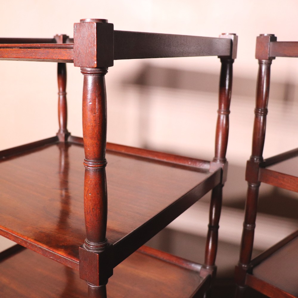 A matching pair of George IV mahogany whatnots featuring five open tiered shelves with turned supports, a single base drawer, and brass castors. View IX