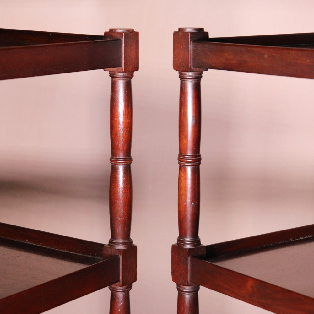 A matching pair of George IV mahogany whatnots featuring five open tiered shelves with turned supports, a single base drawer, and brass castors. View XI