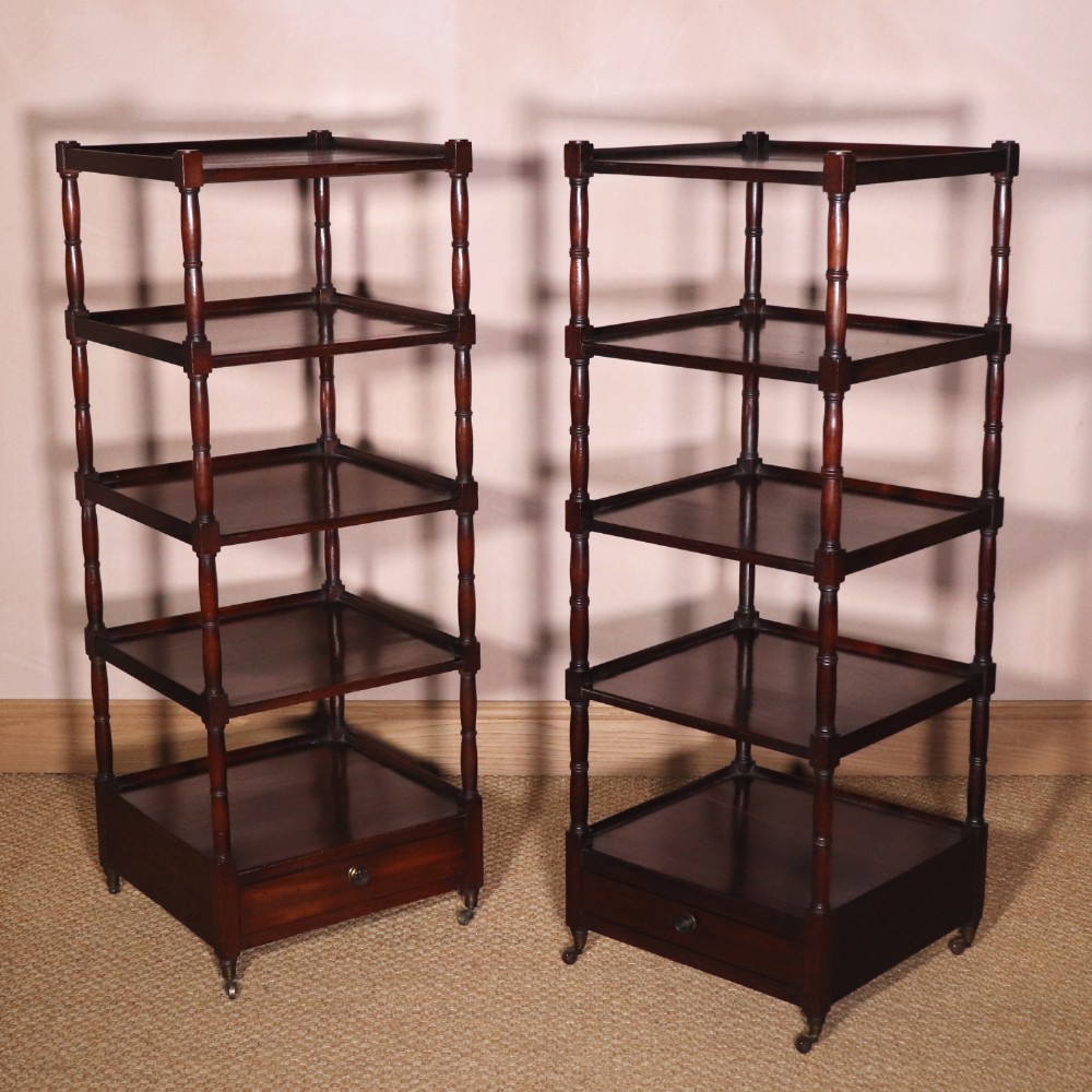 A matching pair of George IV mahogany whatnots featuring five open tiered shelves with turned supports, a single base drawer, and brass castors. View XIII