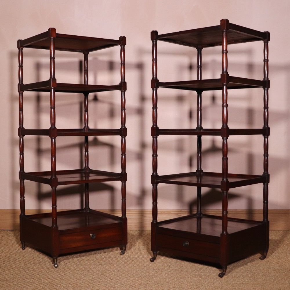 A matching pair of George IV mahogany whatnots featuring five open tiered shelves with turned supports, a single base drawer, and brass castors. View XIV