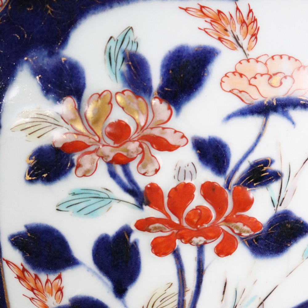 A pair of early eighteenth-century Japanese Arita porcelain lidded jars decorated with cobalt blue, red, and gold floral patterns. View III