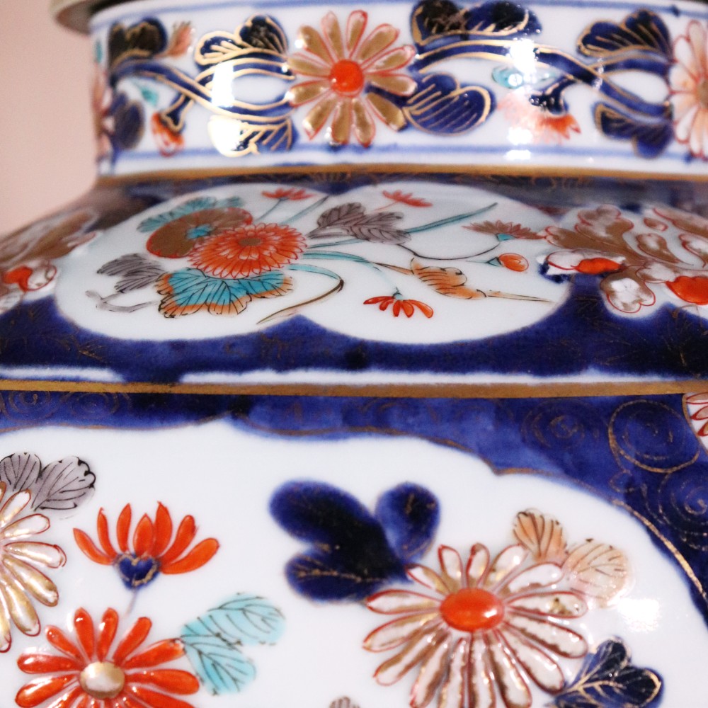 A pair of early eighteenth-century Japanese Arita porcelain lidded jars decorated with cobalt blue, red, and gold floral patterns. View IV