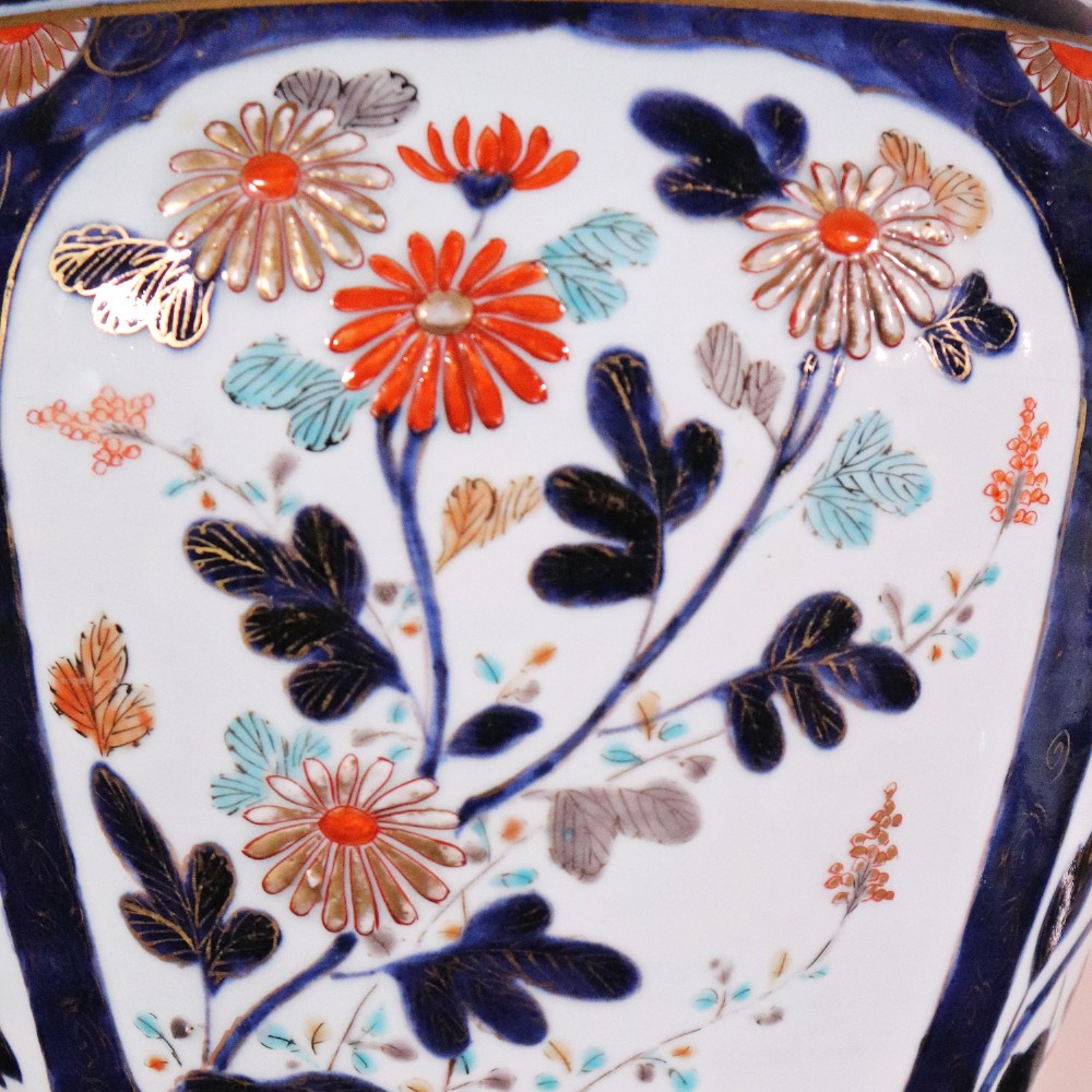 A pair of early eighteenth-century Japanese Arita porcelain lidded jars decorated with cobalt blue, red, and gold floral patterns. View VI
