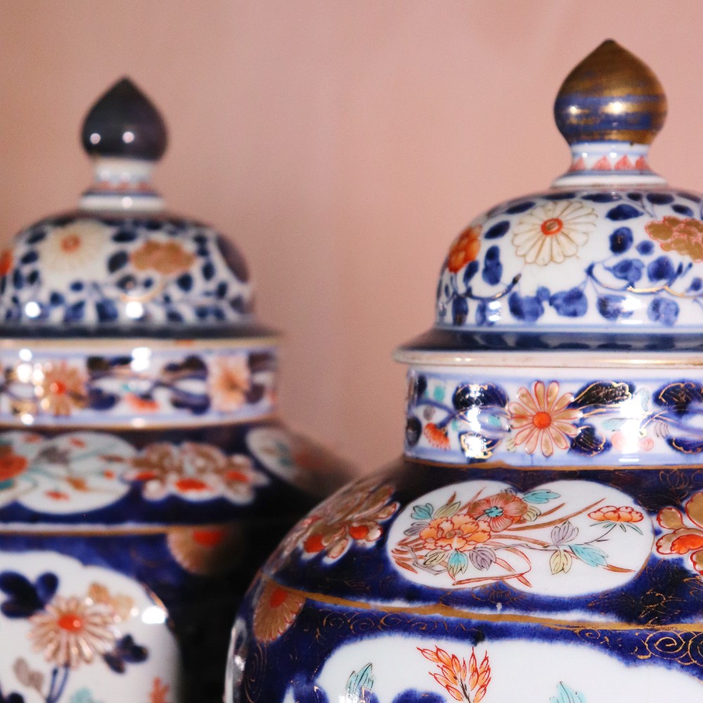 A pair of early eighteenth-century Japanese Arita porcelain lidded jars decorated with cobalt blue, red, and gold floral patterns. View VII