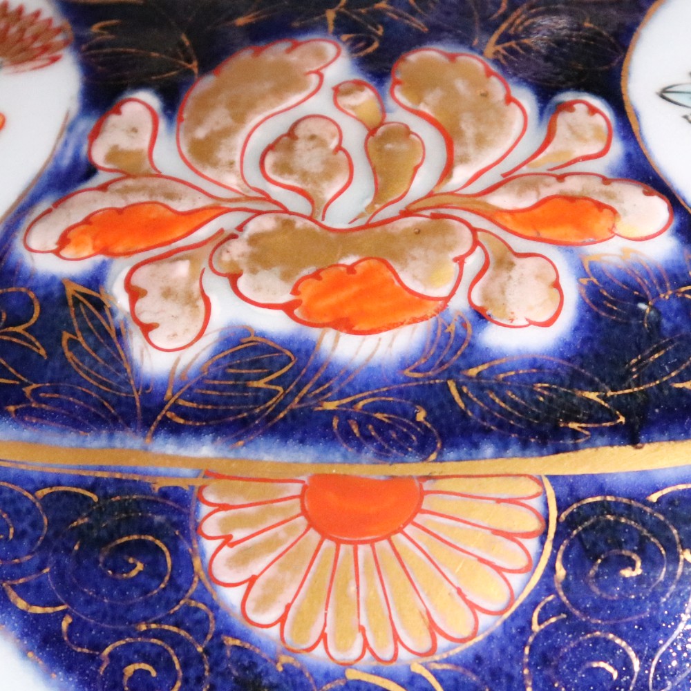 A pair of early eighteenth-century Japanese Arita porcelain lidded jars decorated with cobalt blue, red, and gold floral patterns. View IX