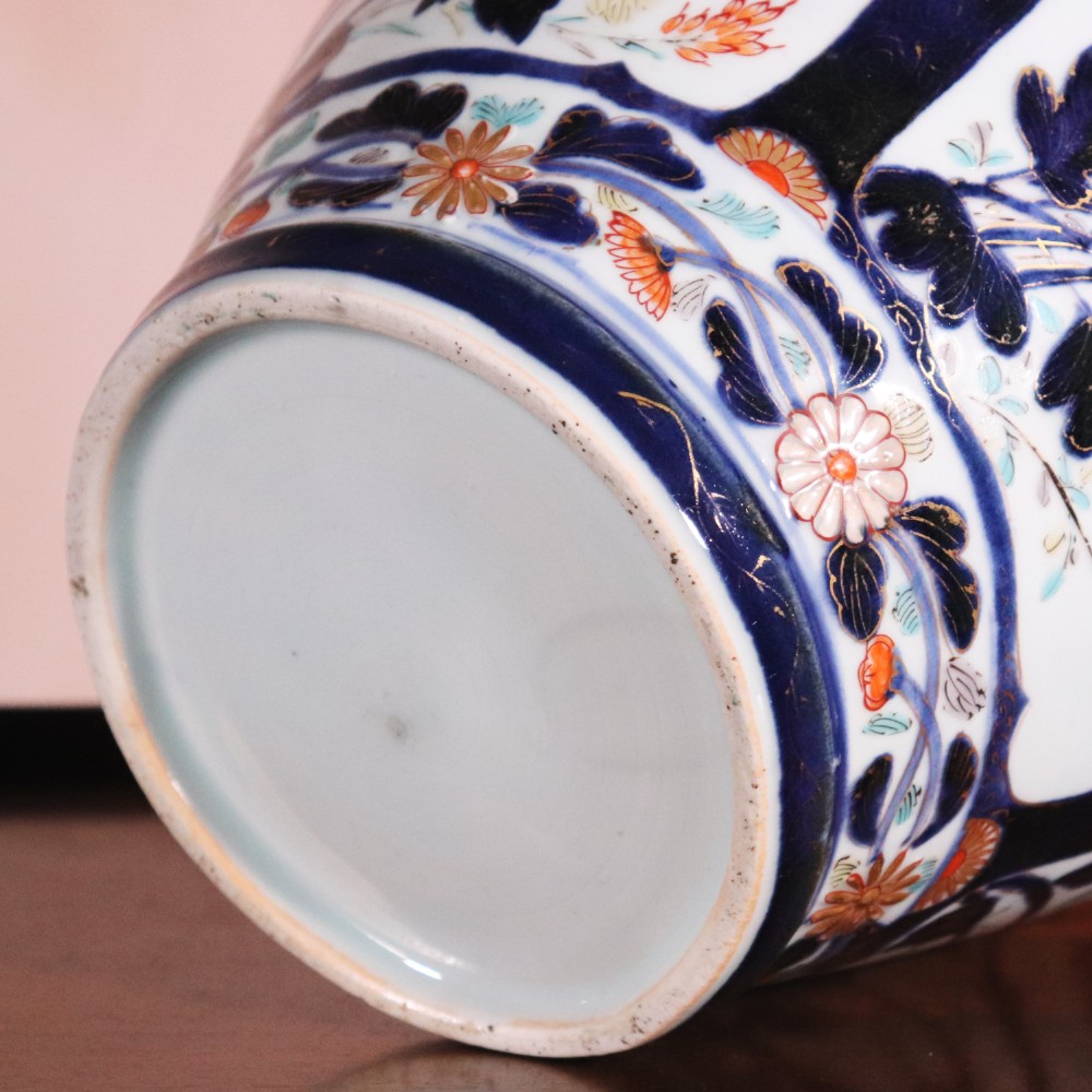 A pair of early eighteenth-century Japanese Arita porcelain lidded jars decorated with cobalt blue, red, and gold floral patterns. View XII