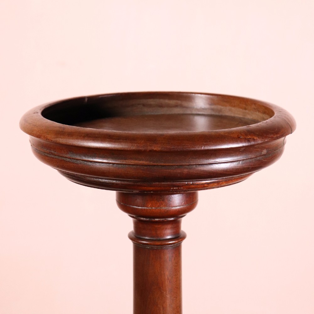 A George II dark mahogany torchere featuring a dished top, turned baluster column, and a tripod base with pad feet. View II