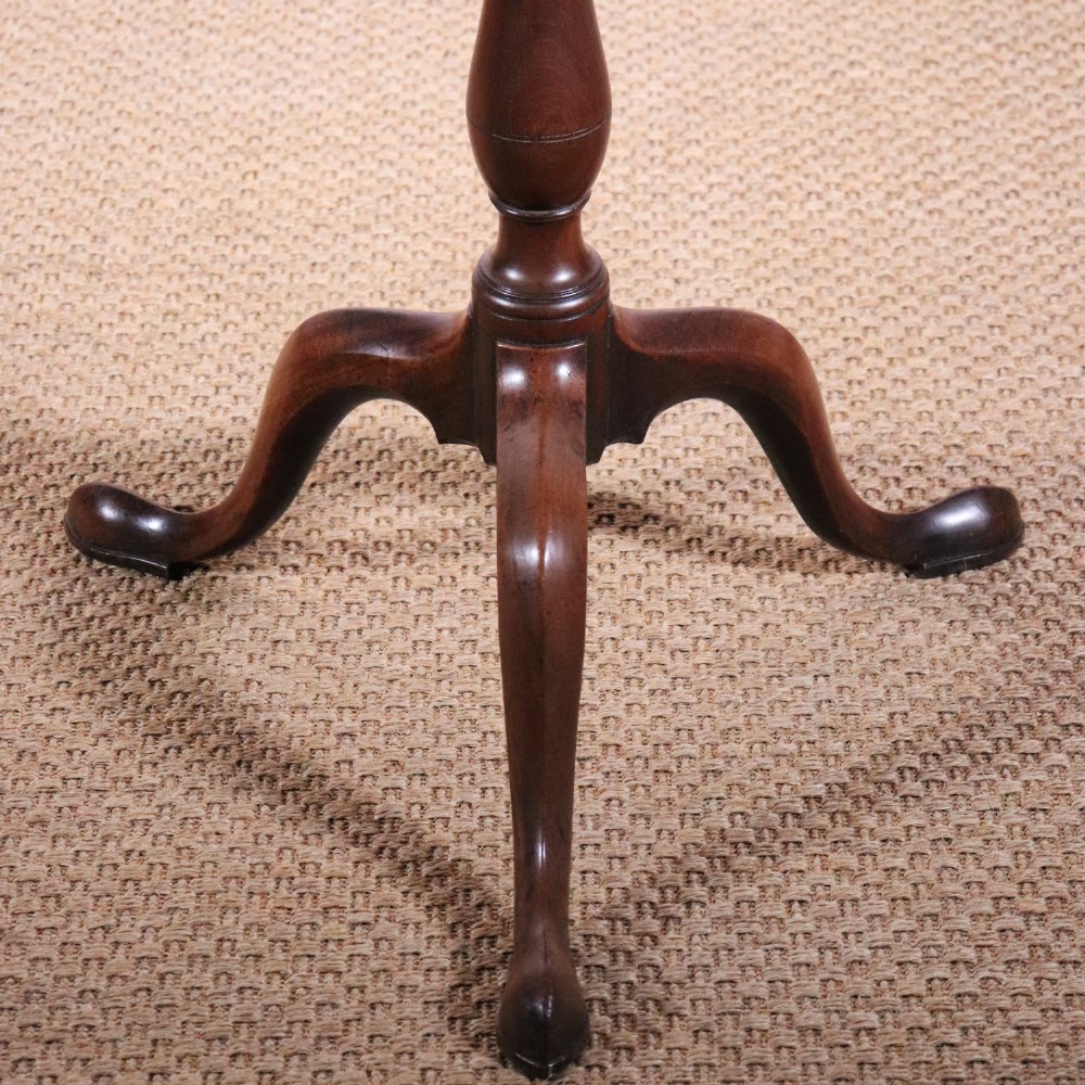 A George II dark mahogany torchere featuring a dished top, turned baluster column, and a tripod base with pad feet. View VI