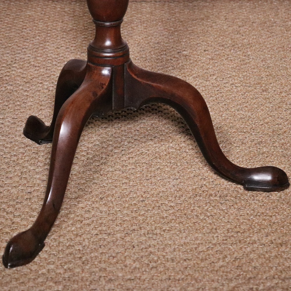 A George II dark mahogany torchere featuring a dished top, turned baluster column, and a tripod base with pad feet. View VII