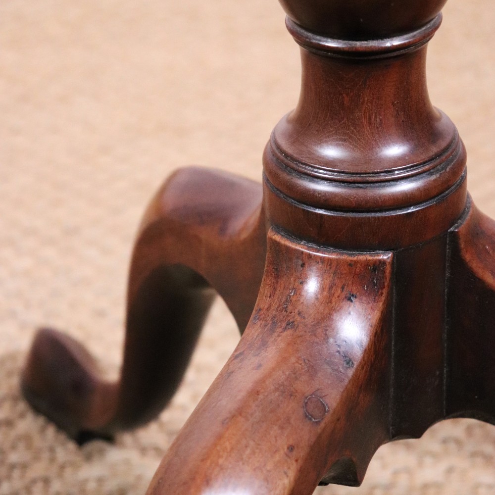 A George II dark mahogany torchere featuring a dished top, turned baluster column, and a tripod base with pad feet. View VIII