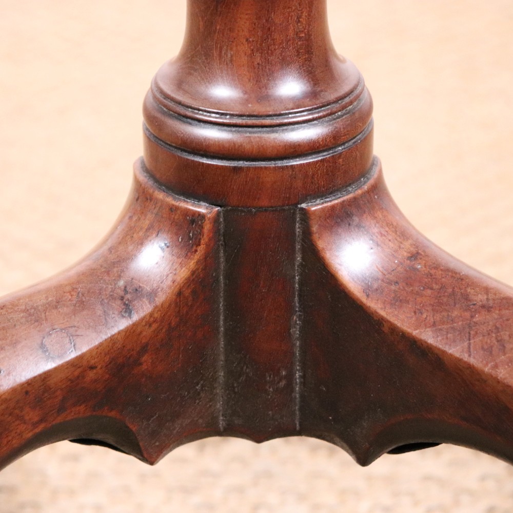 A George II dark mahogany torchere featuring a dished top, turned baluster column, and a tripod base with pad feet. View IX