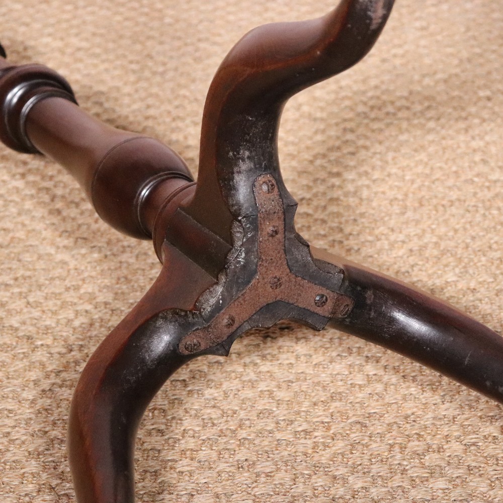 A George II dark mahogany torchere featuring a dished top, turned baluster column, and a tripod base with pad feet. View XII