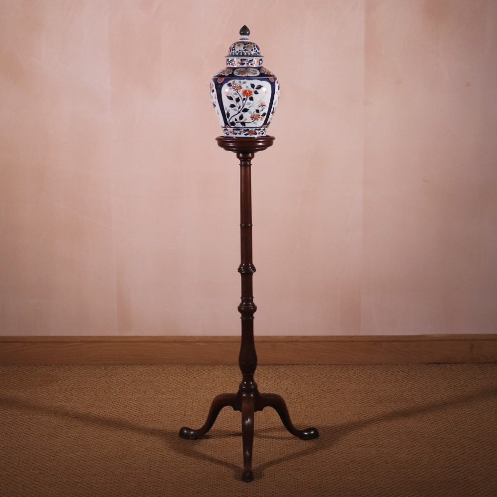 A George II dark mahogany torchere featuring a dished top, turned baluster column, and a tripod base with pad feet. View XIII