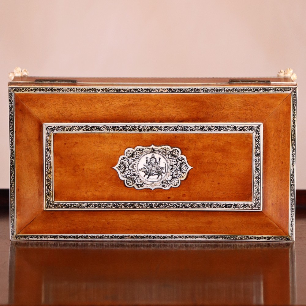 A rectangular sandalwood card box with penwork-engraved ivory borders, carved lion-paw feet, and a central medallion motif. View III