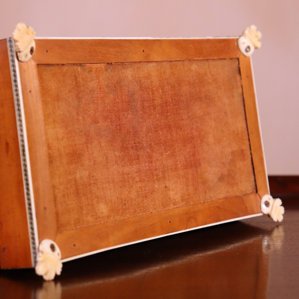 A rectangular sandalwood card box with penwork-engraved ivory borders, carved lion-paw feet, and a central medallion motif. View VII