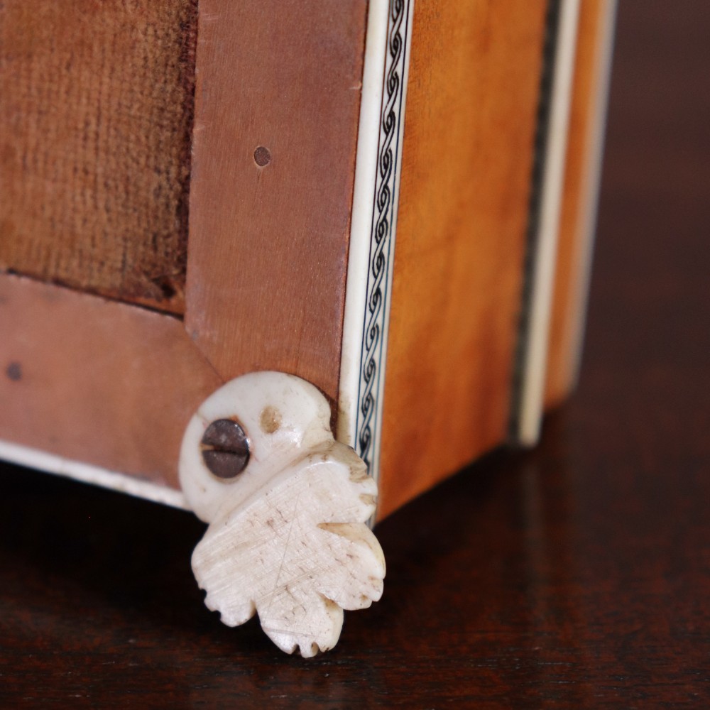 A rectangular sandalwood card box with penwork-engraved ivory borders, carved lion-paw feet, and a central medallion motif. View VIII