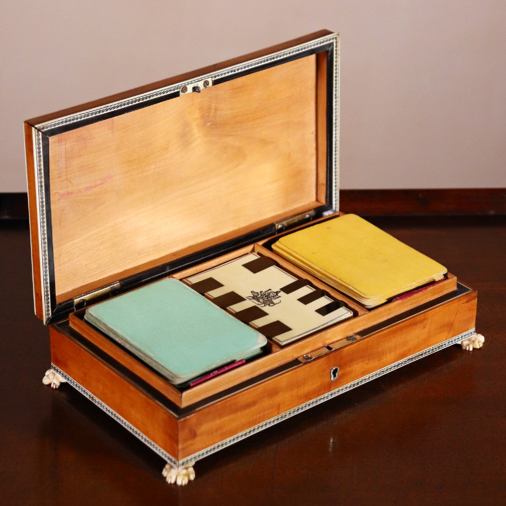 A rectangular sandalwood card box with penwork-engraved ivory borders, carved lion-paw feet, and a central medallion motif. View IX