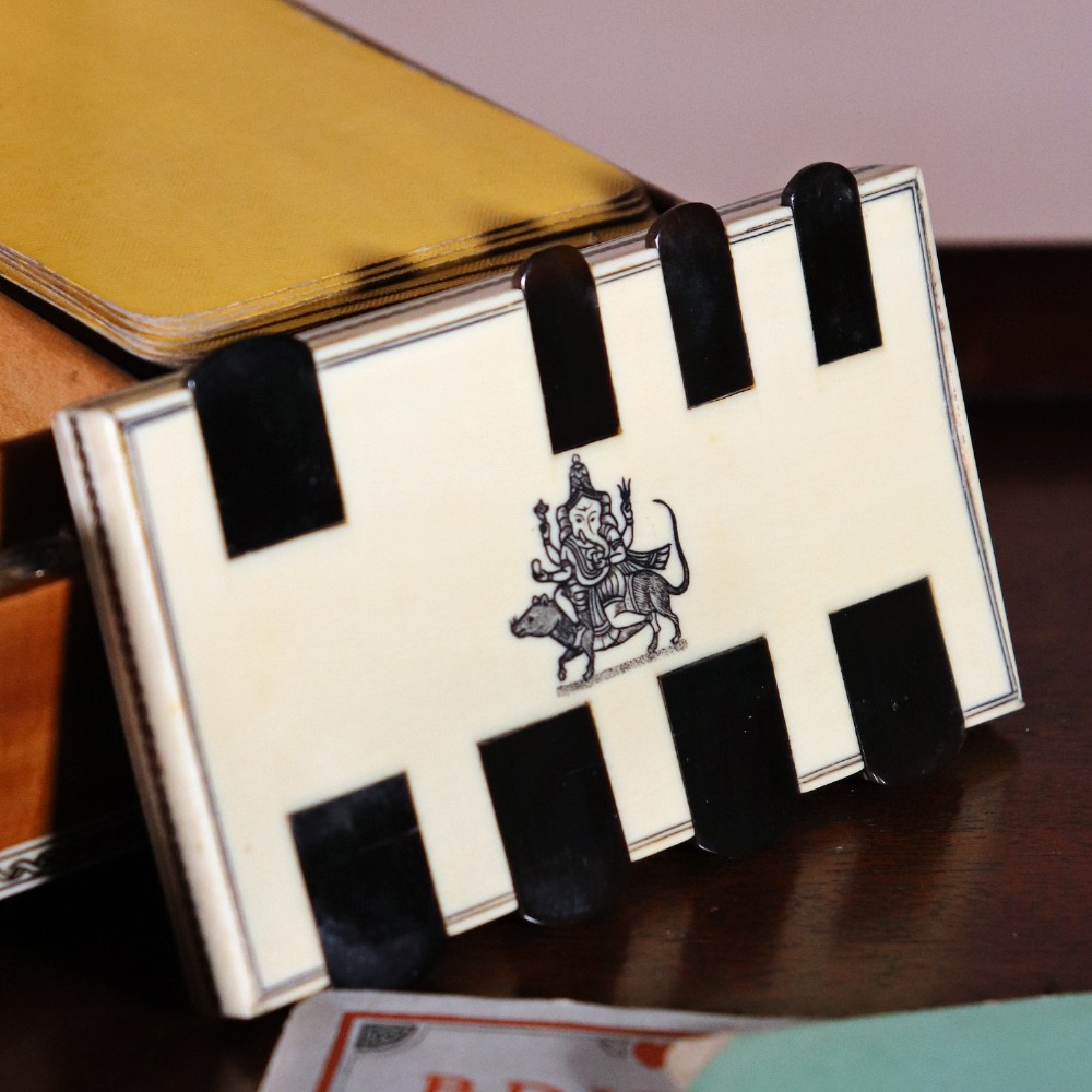 A rectangular sandalwood card box with penwork-engraved ivory borders, carved lion-paw feet, and a central medallion motif. View XI