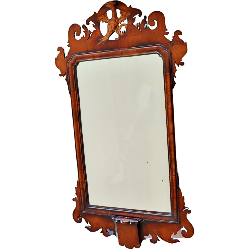 A George III style walnut fretwork wall mirror featuring carved bird cresting, scrollwork borders, and a rectangular mirror plate.