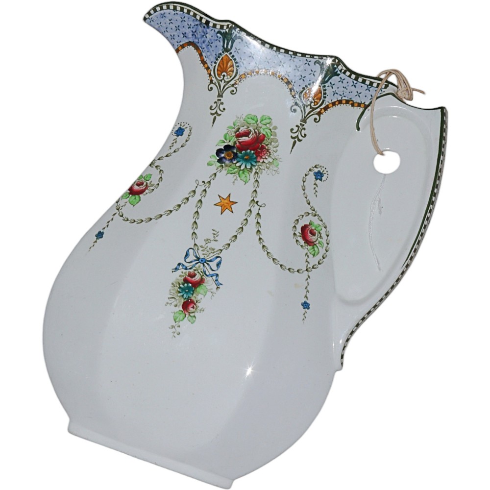 A Victorian ceramic wash jug salesman sample featuring polychrome floral swags, ribbon motifs, and decorative border detailing against a white glazed surface.