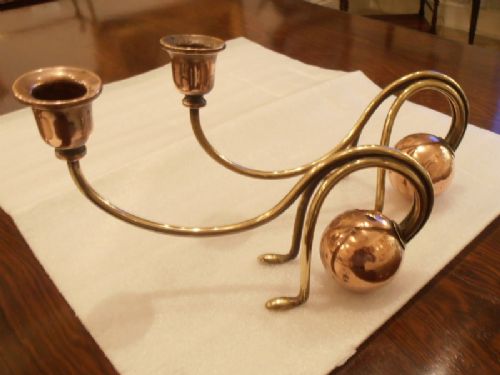 A Pair of Brass and Copper Candlesticks in W.a.s. Benson Manner