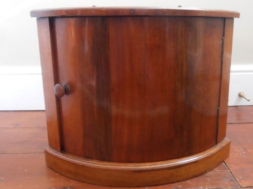 A Small Mahogany Corner Cupboard with Bow Front Door