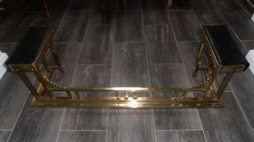A Brass Art Deco Club Fender with Two Black Leather Seats
