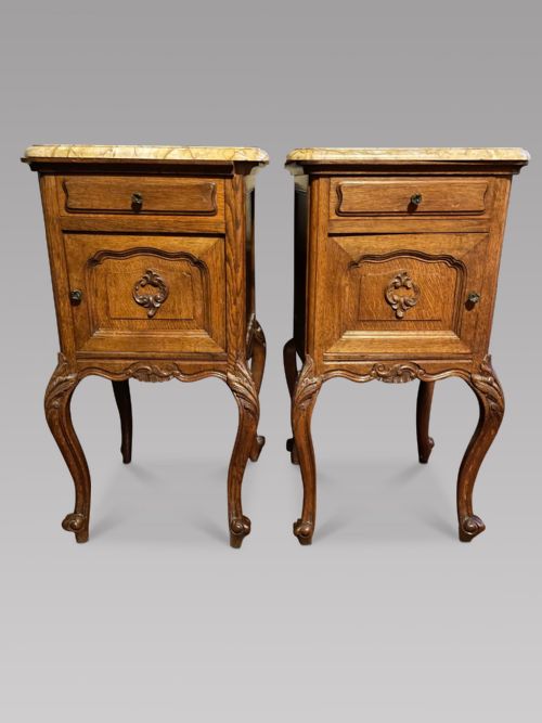 A Pair of Carved Oak Bedside Cupboards