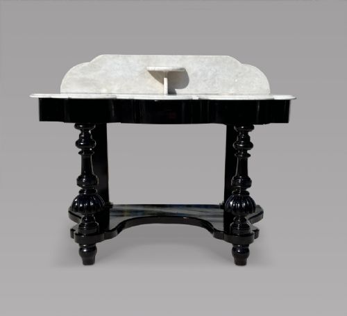 A Serpentine Ebonised Marble Topped Table