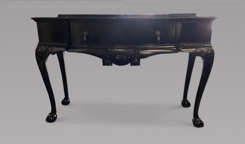 A Serpentine Ebonised Table