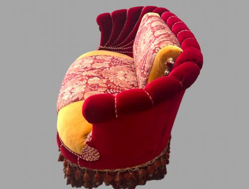 fig 3. An Austro-Hungarian shell-shaped sofa featuring deep red velvet scalloped back upholstery, a gold velvet seat with patterned brocade central panels, and dramatic tasselled fringe along the base.