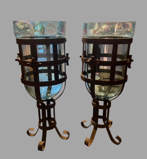 A Pair of Wrought Iron Hurricane Lanterns