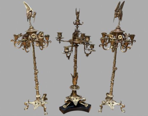 fig 1. Set of ornate 19th-century French gilt bronze candelabra featuring foliate stems, scrolled arms, tripod bases, and detailed bird finials.