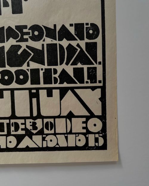fig 4. A vertical monochrome Art Deco graphic poster featuring a stylised goalkeeper reaching for a ball above dynamic Spanish text for the 1930 World Cup in Uruguay.