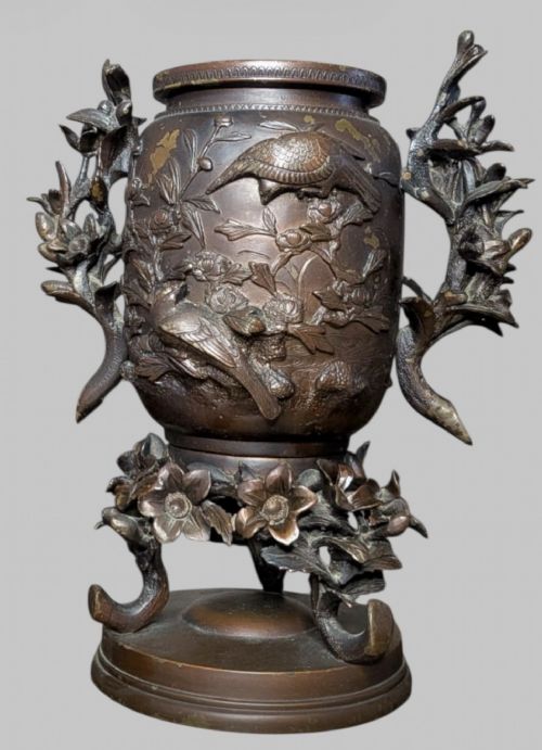 fig 3. An antique cast bronze Japanese incense burner featuring a goat finial, foliage handles, bird relief panels, and a stepped circular base.