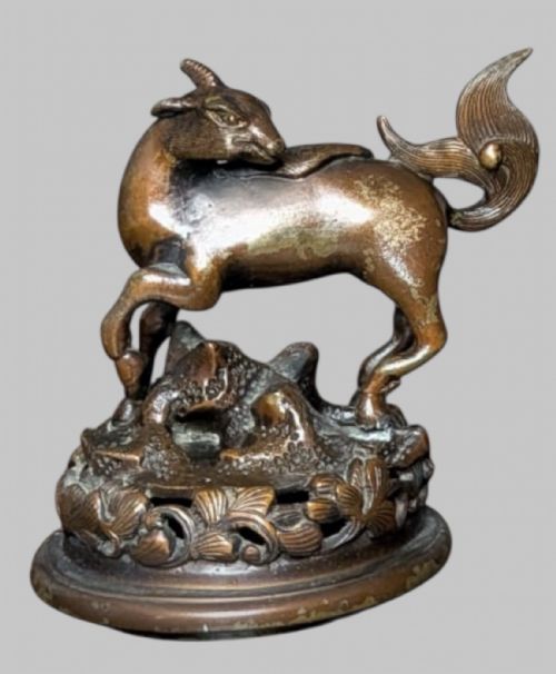fig 4. An antique cast bronze Japanese incense burner featuring a goat finial, foliage handles, bird relief panels, and a stepped circular base.