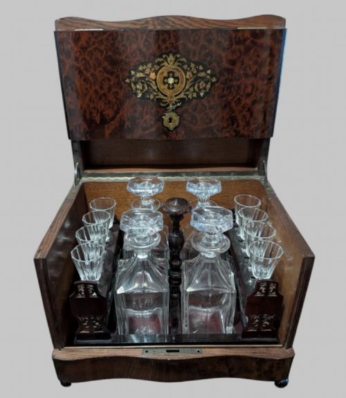 fig 2. An open 19th-century French Napoleon III wooden cave a liqueur box featuring inlaid lid detailing and a removable tier holding cut-glass decanters and small glasses.