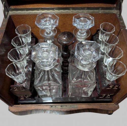 fig 3. An open 19th-century French Napoleon III wooden cave a liqueur box featuring inlaid lid detailing and a removable tier holding cut-glass decanters and small glasses.