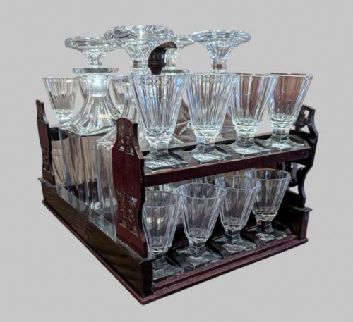 fig 4. An open 19th-century French Napoleon III wooden cave a liqueur box featuring inlaid lid detailing and a removable tier holding cut-glass decanters and small glasses.
