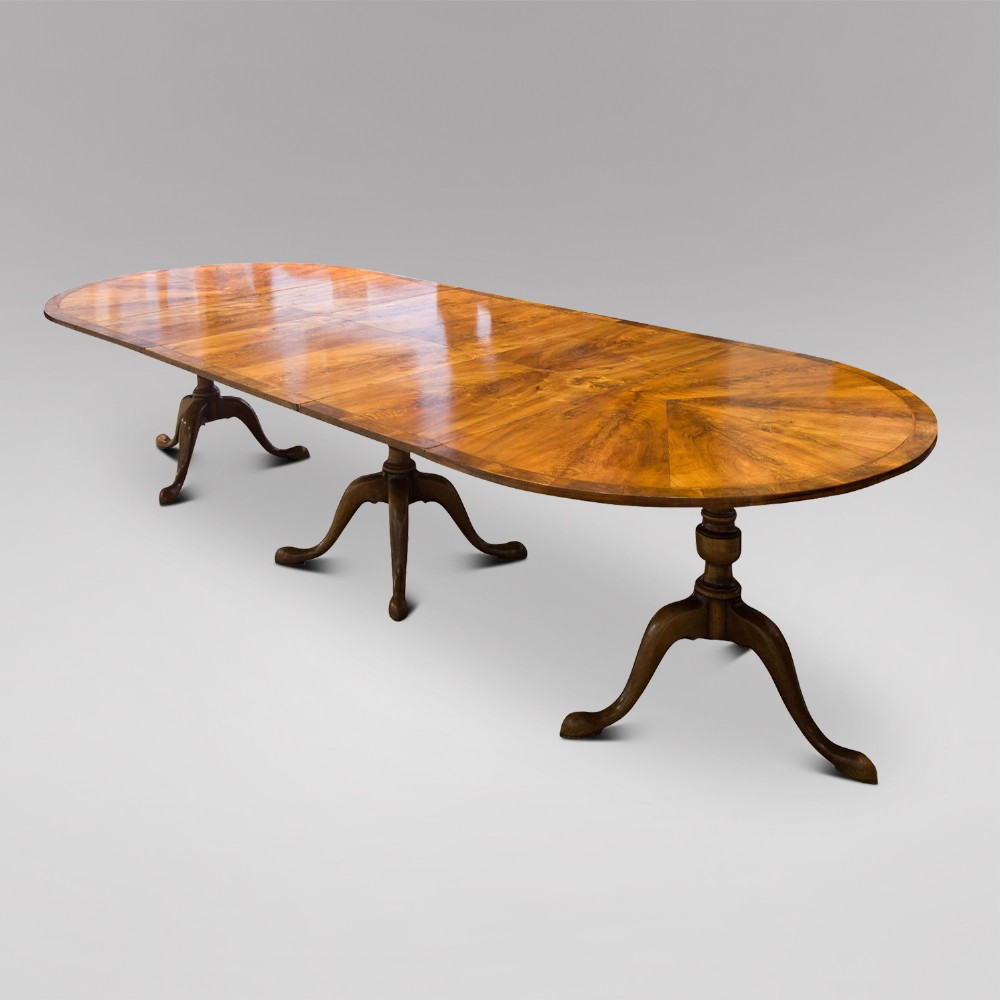 A c1900 Walnut Dining Table with two leaves and three pedestals 