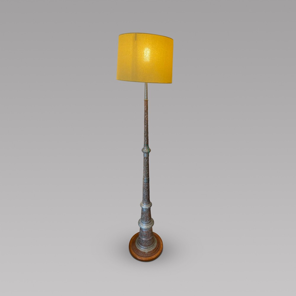 A Eastern Embossed Copper and Silvered Lamp
