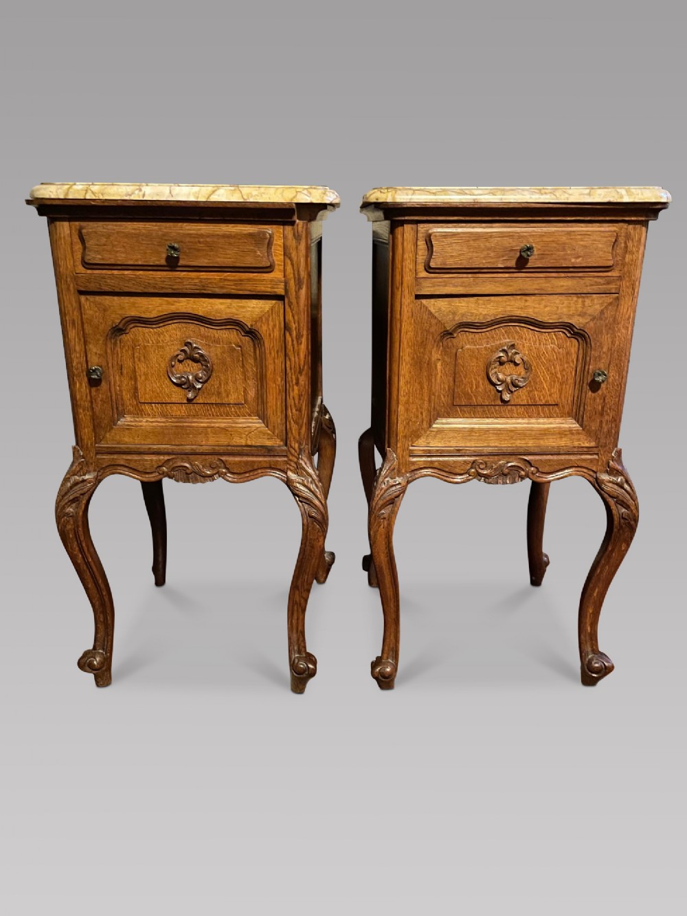 A Pair of Carved Oak bedside cupboards