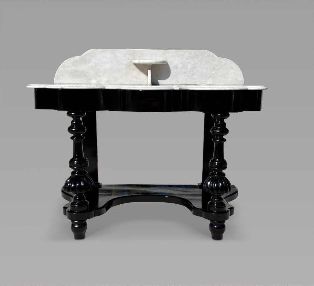 A Serpentine Ebonised Marble Topped Table