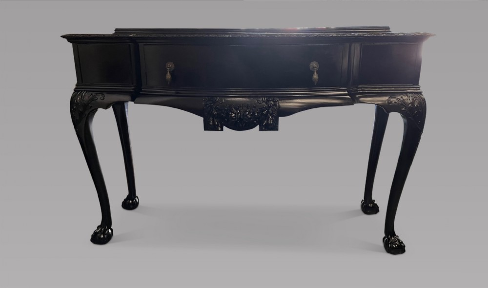 A Serpentine Ebonised Table