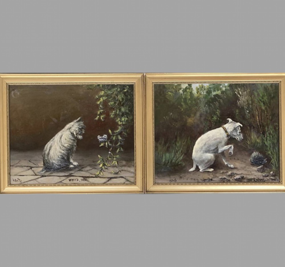 A pair of small framed oil paintings depicting white terriers outdoors in gold leaf frames.