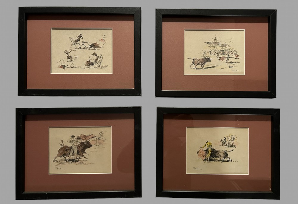 Set of four framed coloured etchings depicting traditional Spanish bullfighting scenes with matadors and picadors, presented in terracotta-toned mounts and black frames.