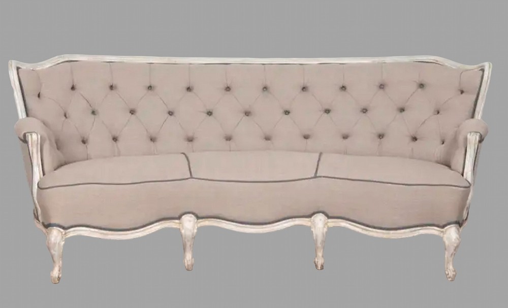 A 19th-century French style upholstered settee with a distressed painted serpentine frame, button-tufted backrest, and cabriole legs.