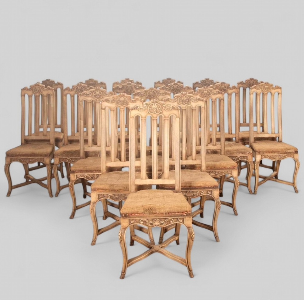 A Set of Eighteen French Bleached Walnut and Beech Chairs